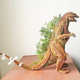 Illustration for article titled Godzilla Made from Pine Tree Branches Is a Lovely Fire Hazard